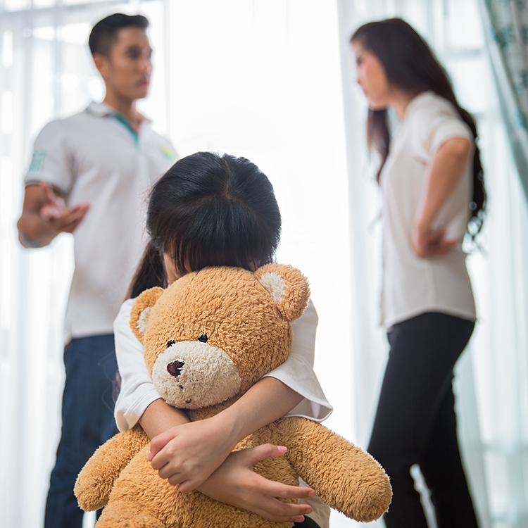 Image of a child with parents discussing child custody